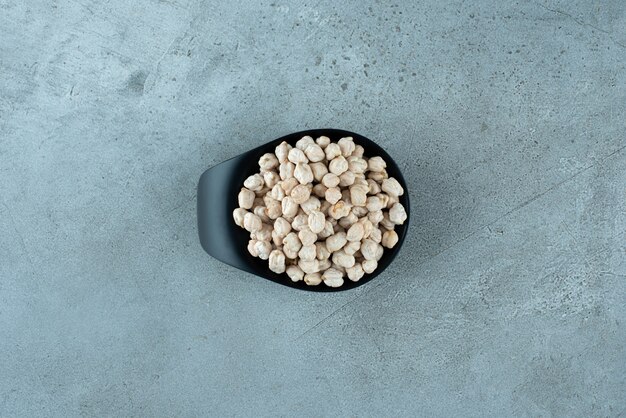 Raw pea beans in a black cup. High quality photo