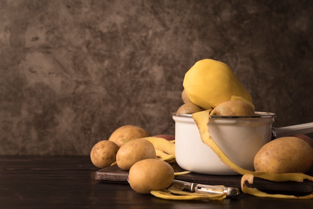 Raw potatoes in bowls with copy space