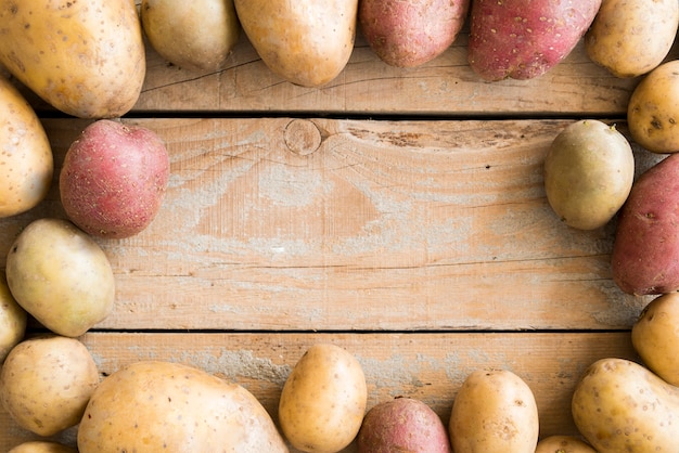 Raw potatoes frame with copy space