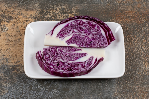 Raw purple cabbage in the bowl on the marble surface