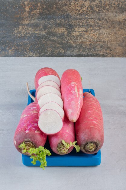 Raw red turnips on blue plate. High quality photo