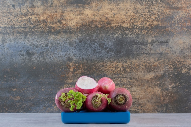 Raw red turnips on blue plate. High quality photo