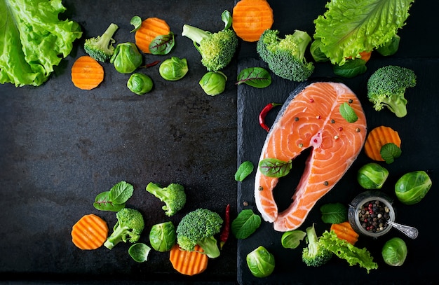 Raw salmon steak and ingredients for cooking. Top view
