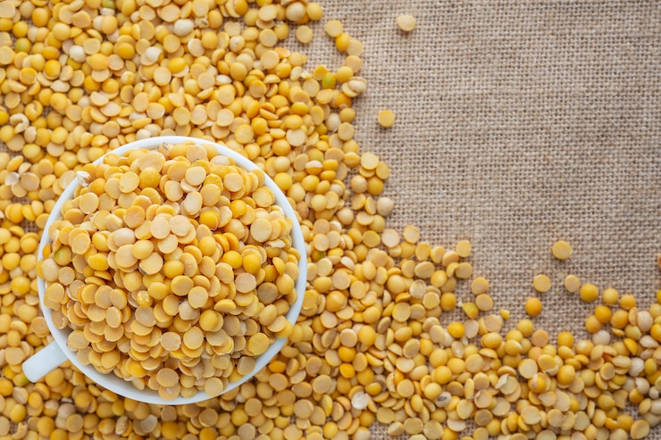 Free Photo raw soybeans in a white glass placed on a floor.