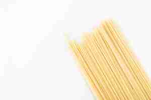 Free photo raw spaghetti pasta on white.