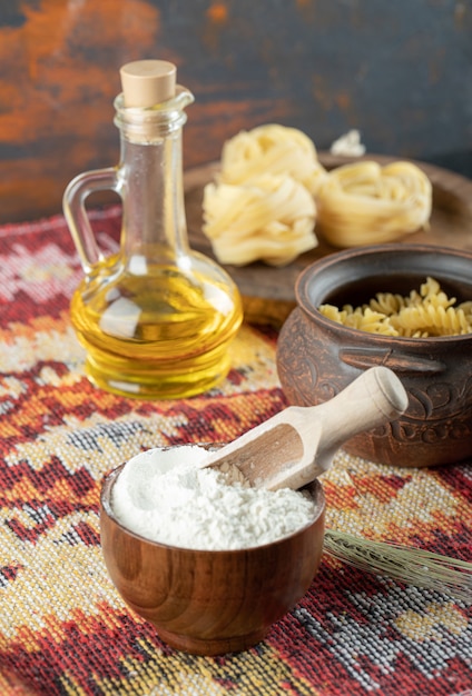 Raw spiral pasta in pot with fettuccine uncooked macaroni