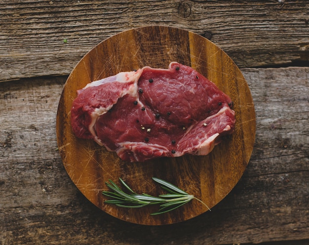 Free photo raw steak on brown table