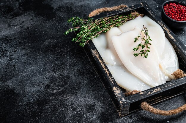 Premium Photo Raw Calamari Or Squid On A Wooden Board With Rosemary
