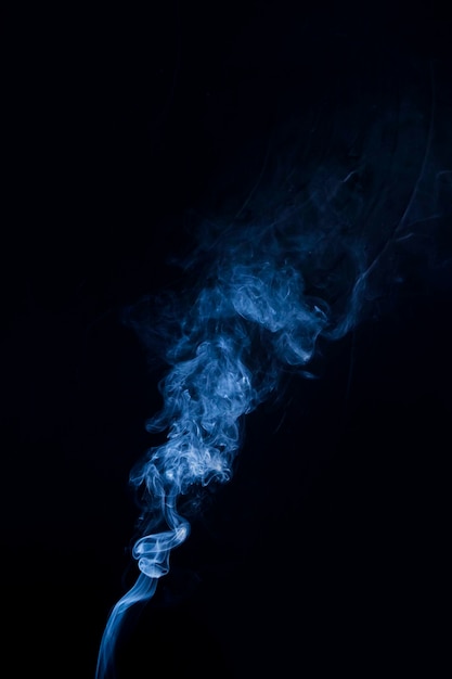 Real blue smoke billowing up on black background