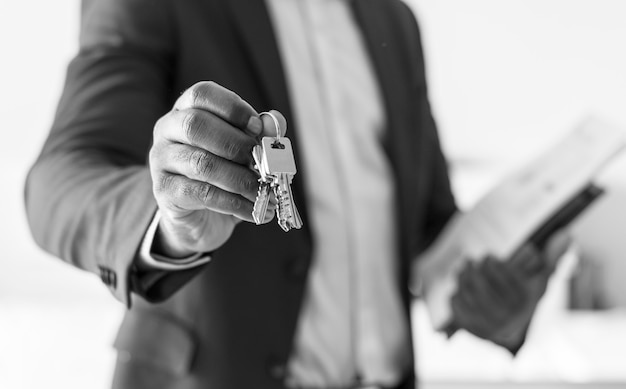 Free photo real estate agent handing the house key