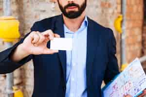 Free photo real estate agent holding business card