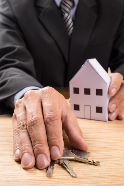 Real estate agent with house model and keys