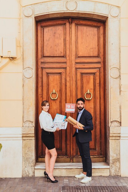 Real estate agents posing at the main door