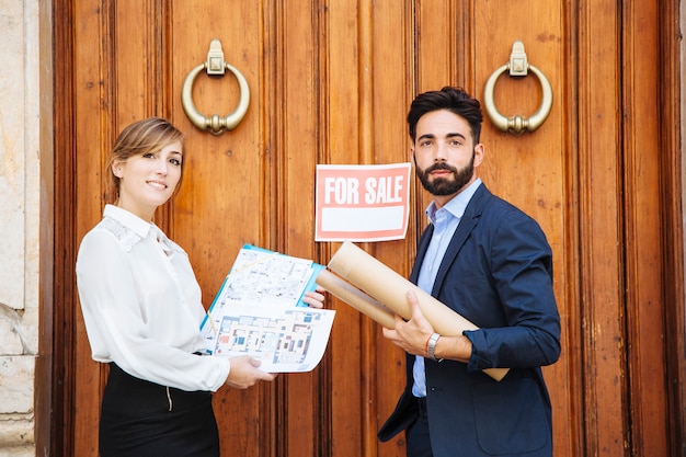 Free photo real estate agents waiting in front of door