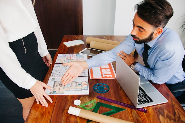 Free photo real estate businessman reaching out hand