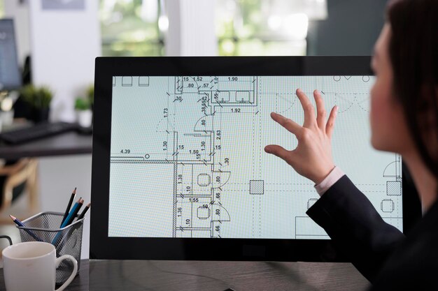 Real estate studio employee working in room floor planner