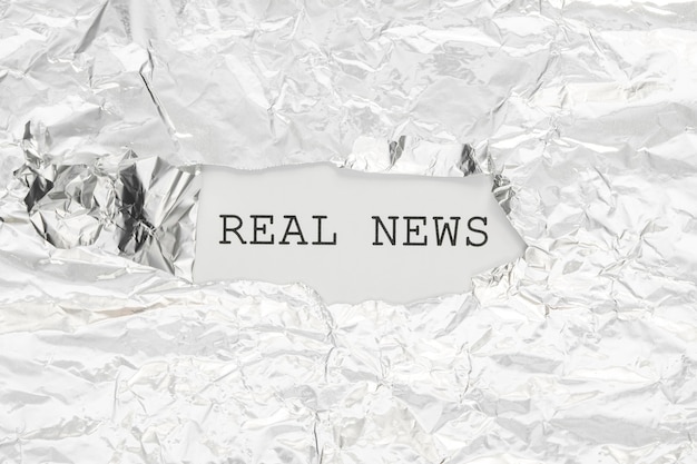 Free photo real news hidden in crumpled paper