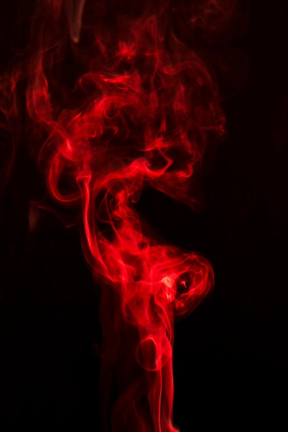 Realistic red smoke on black background