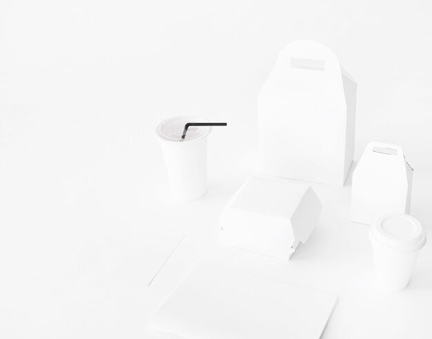 Realistic set of fast food packaging from paper on white backdrop
