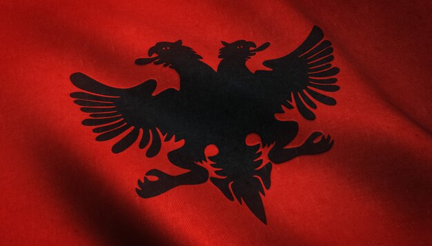 アルバニアの旗が振られている現実的な写真と興味深いテクスチャー