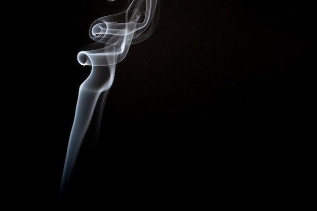 Free photo realistic shot of a wisp of smoke against a black background