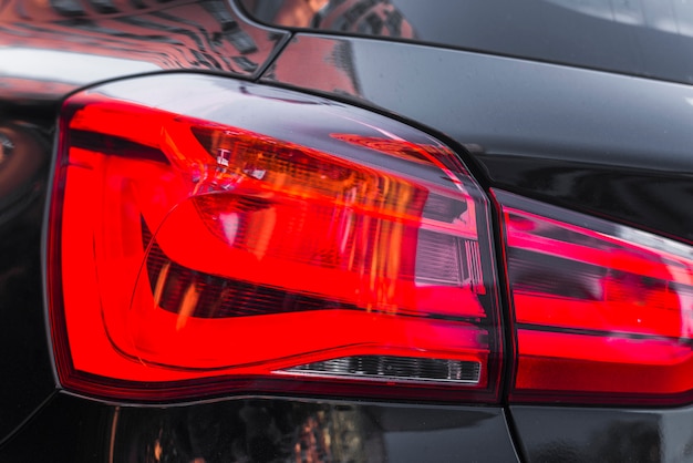 Rear light on modern black automobile