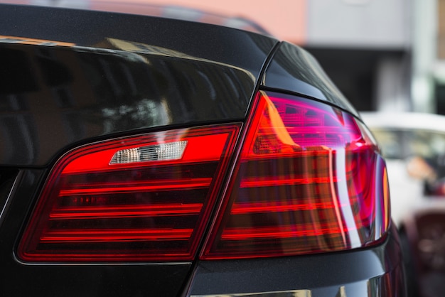 Rear light on new black car on street 