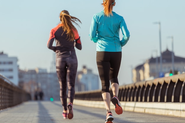 Rear view of active teenagers running