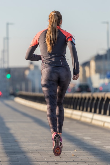 Free photo rear view of active woman running
