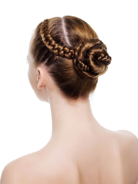 Rear view of a beautiful  coiffure from pigtails. On 