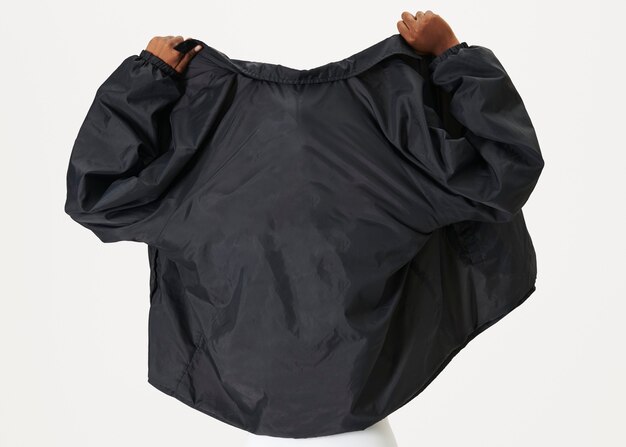 Rear view of a black woman wearing a black jacket 