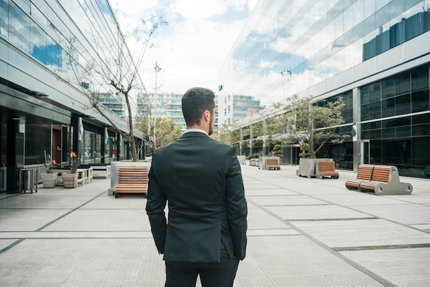 Rear view of a businessman standing on the business campus