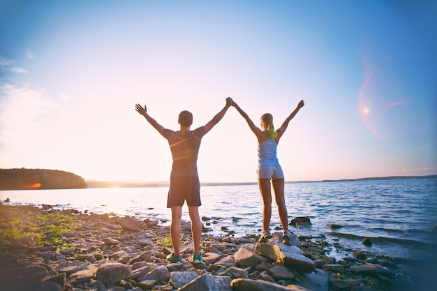 Rear view of couple enjoying a beautiful dawn