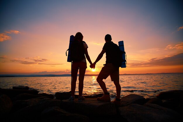 Rear view of couple enjoying the sunset