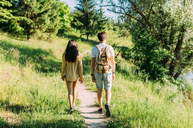 Rear view of couple hiking together at outdoors
