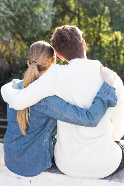 Rear view of couple hugging and enjoying the scenery