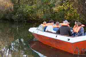 Free photo rear view of family sailing on a boat