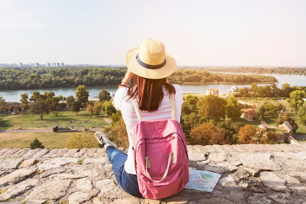 Free photo rear view of a female hiker looking at scenic view