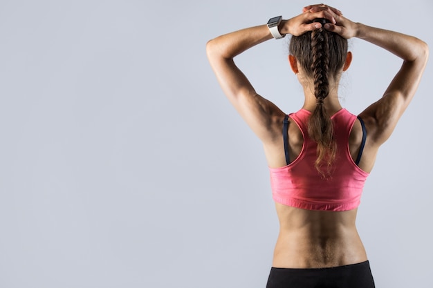 Rear view of fit girl with athletic body