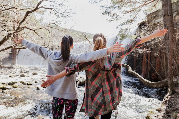 Rear view of girls raising their arms