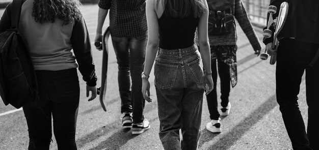 Rear view of group of school friends walking outdoors lifestyle