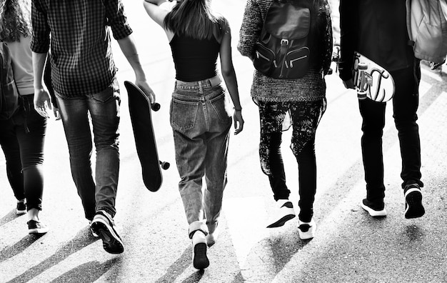 Rear view of group of school friends walking outdoors lifestyle