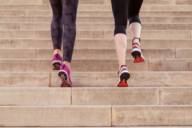 rear view of healthy women climbing stairs