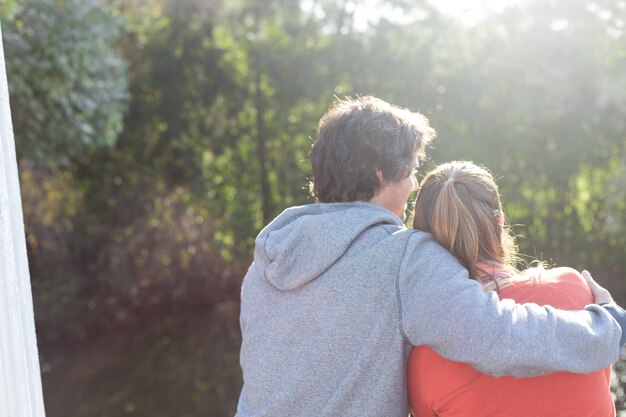 Rear view of lovely couple enjoying the sunset