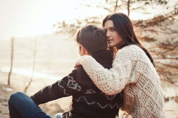 Rear view of lovely couple hugging in winter