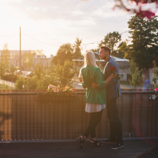 Rear view of lovely young couple standing in balcony