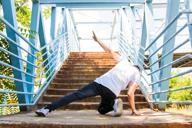 Rear view of a man dancing on stairway