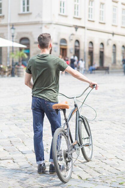 自転車で街に立っている男の後姿