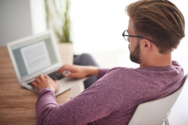 Free photo rear view of man working at home