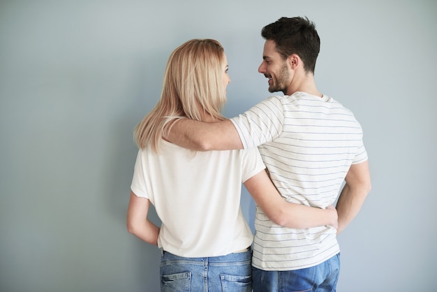 Rear view of newlywed in the grey backrground